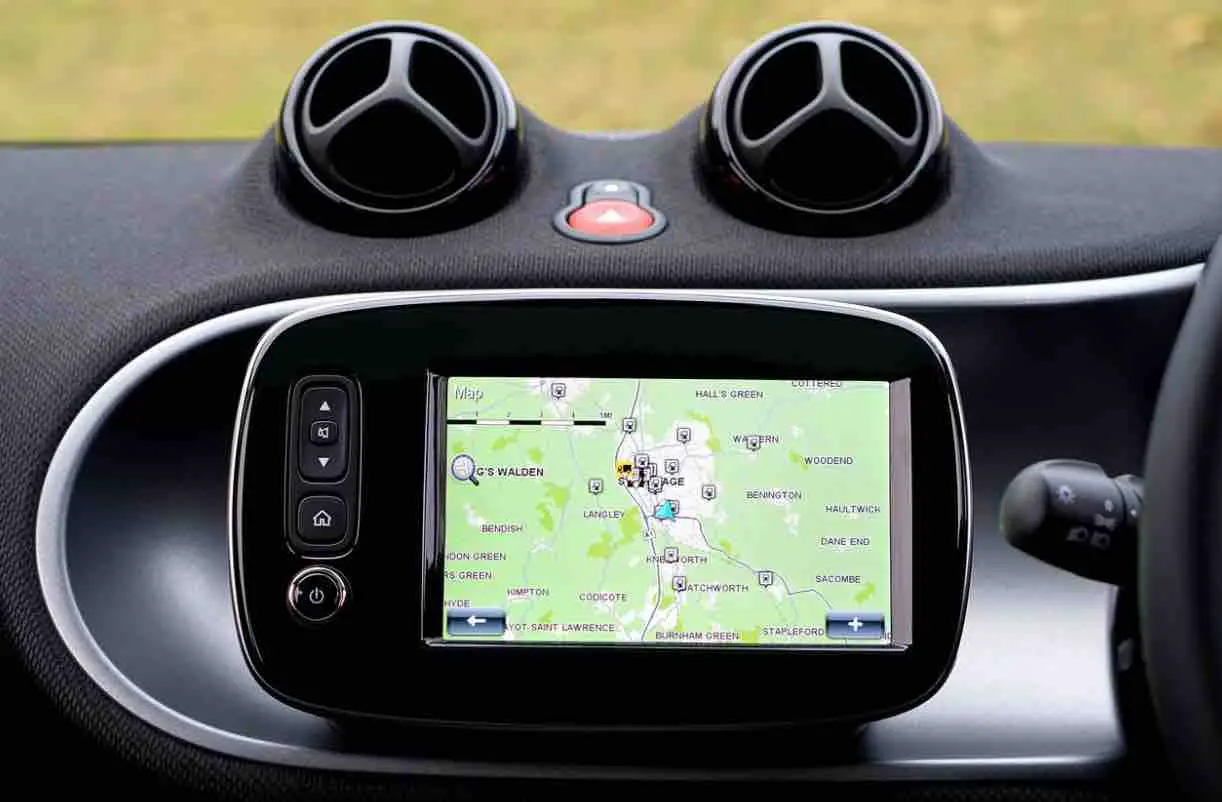 A GPS navigation device with a high-resolution screen and long battery life is mounted on the dashboard of a car.