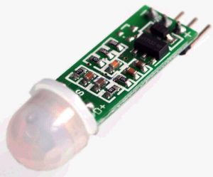 A green circuit board with a white plastic fresnel lens and four metal pins labeled S, D, +, and -.