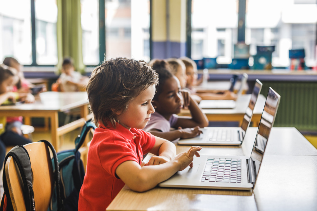 Elementary school students using laptops in the classroom for personalized learning.