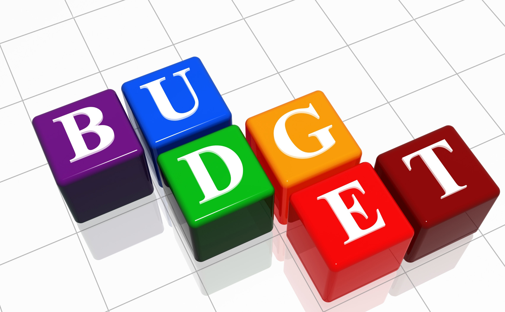 A 3D illustration of multi-colored blocks with white letters spelling out 'BUDGET' on a white grid background.
