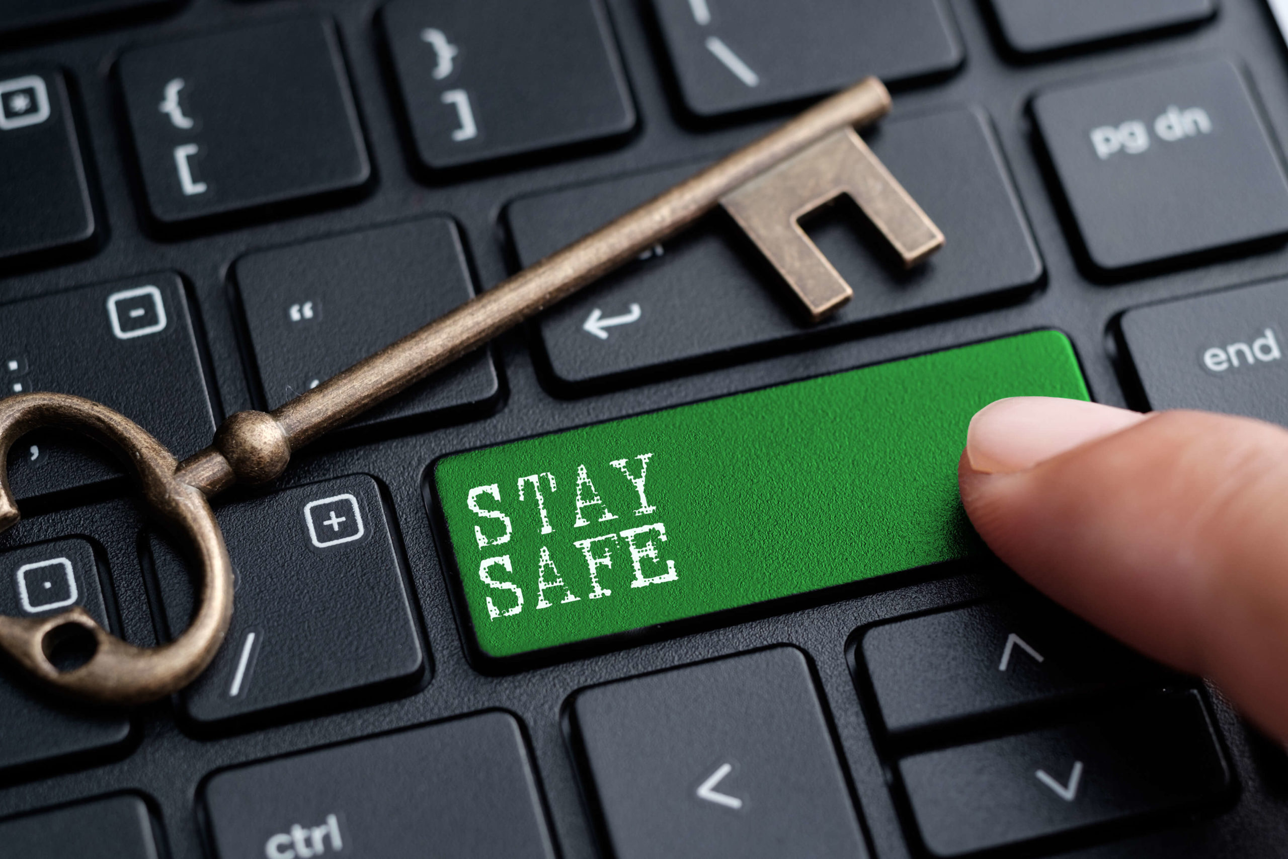 A green button on a keyboard with the words 'STAY SAFE' is pressed by a finger. The image represents the search query 'How to keep your online privacy safe'.