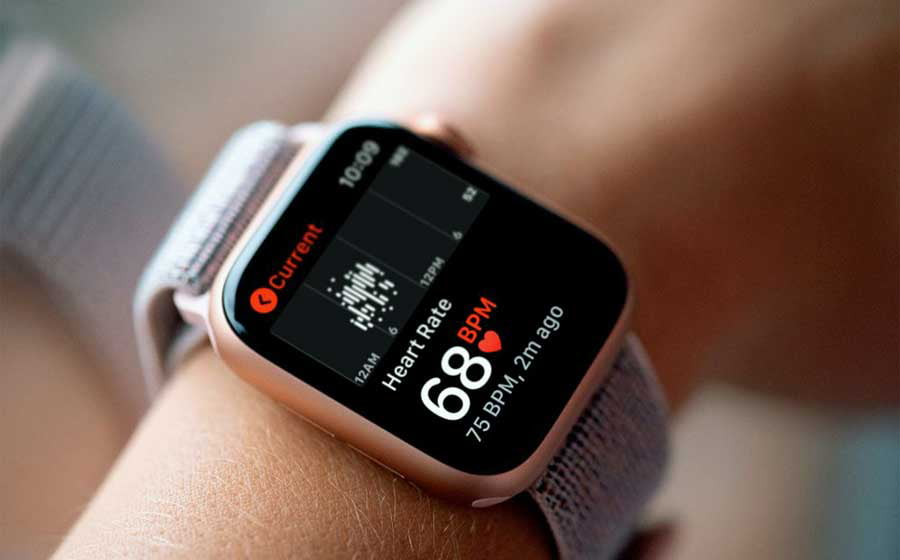 A person wearing a smartwatch that displays the wearer's current heart rate of 68 beats per minute (bpm) along with other health monitoring features.