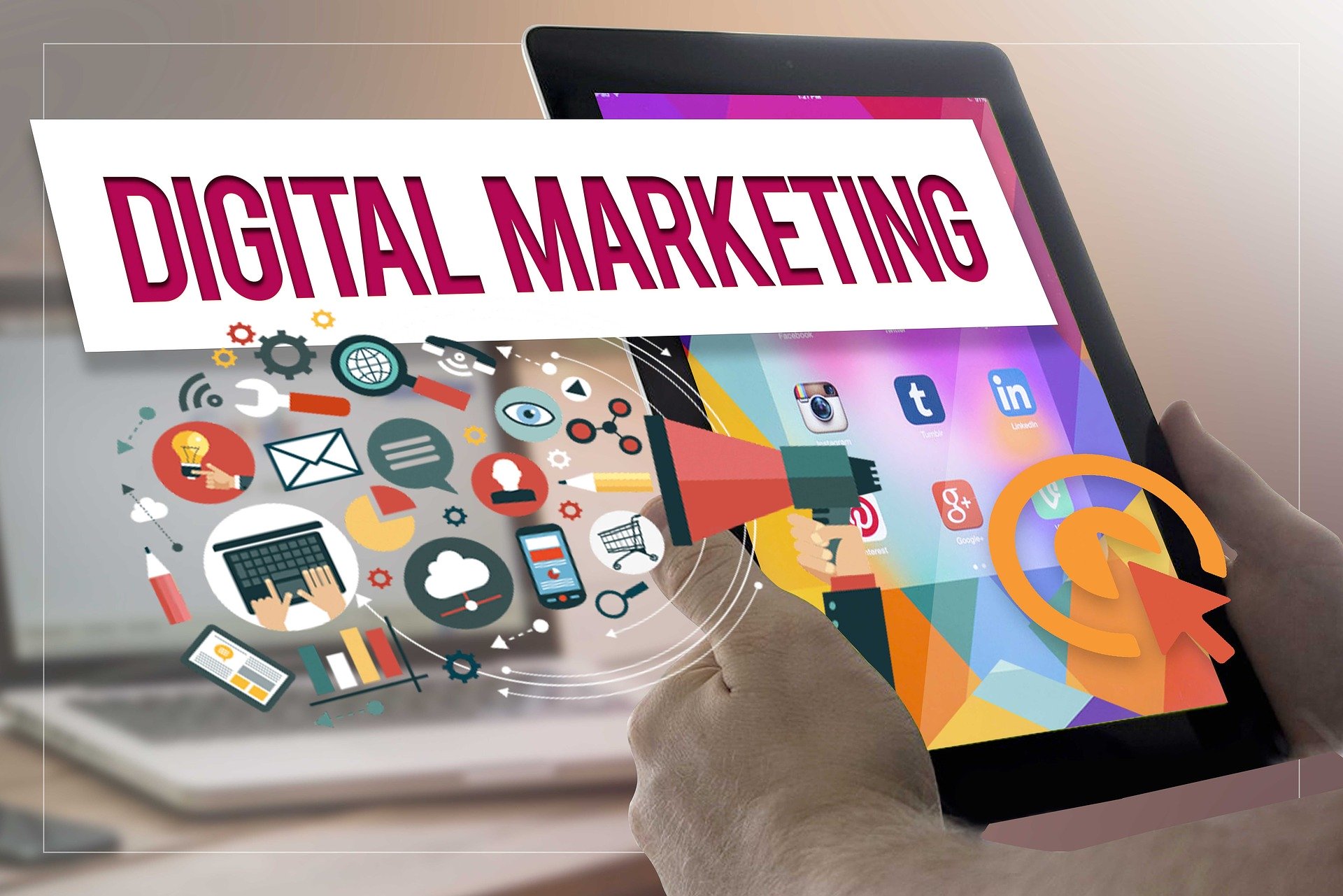 A hand holding a tablet with the words 'Digital Marketing' on the screen, surrounded by icons representing different types of digital marketing campaigns.