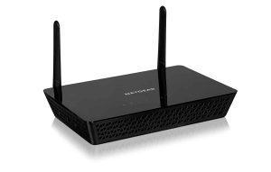 A black Netgear WiFi router sits on a white table against a white background.