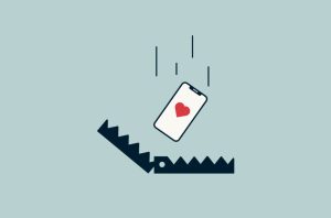 A smartphone with a heart on the screen falls into a bear trap, symbolizing the danger of online dating scams.